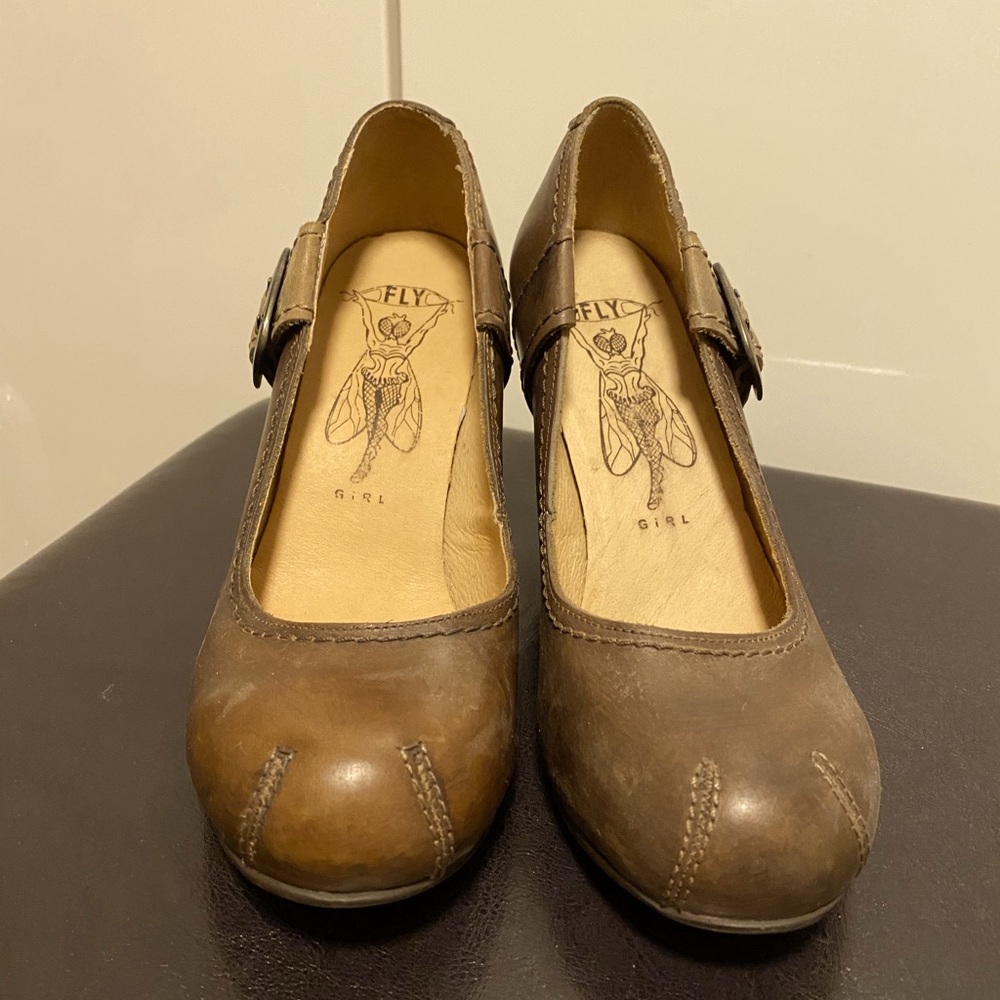Leather, wooden heel. Purchased in Montreal. New.
